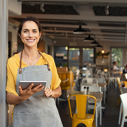 Portrait,Of,Happy,Woman,Standing,At,Doorway,Of,Her,Store.